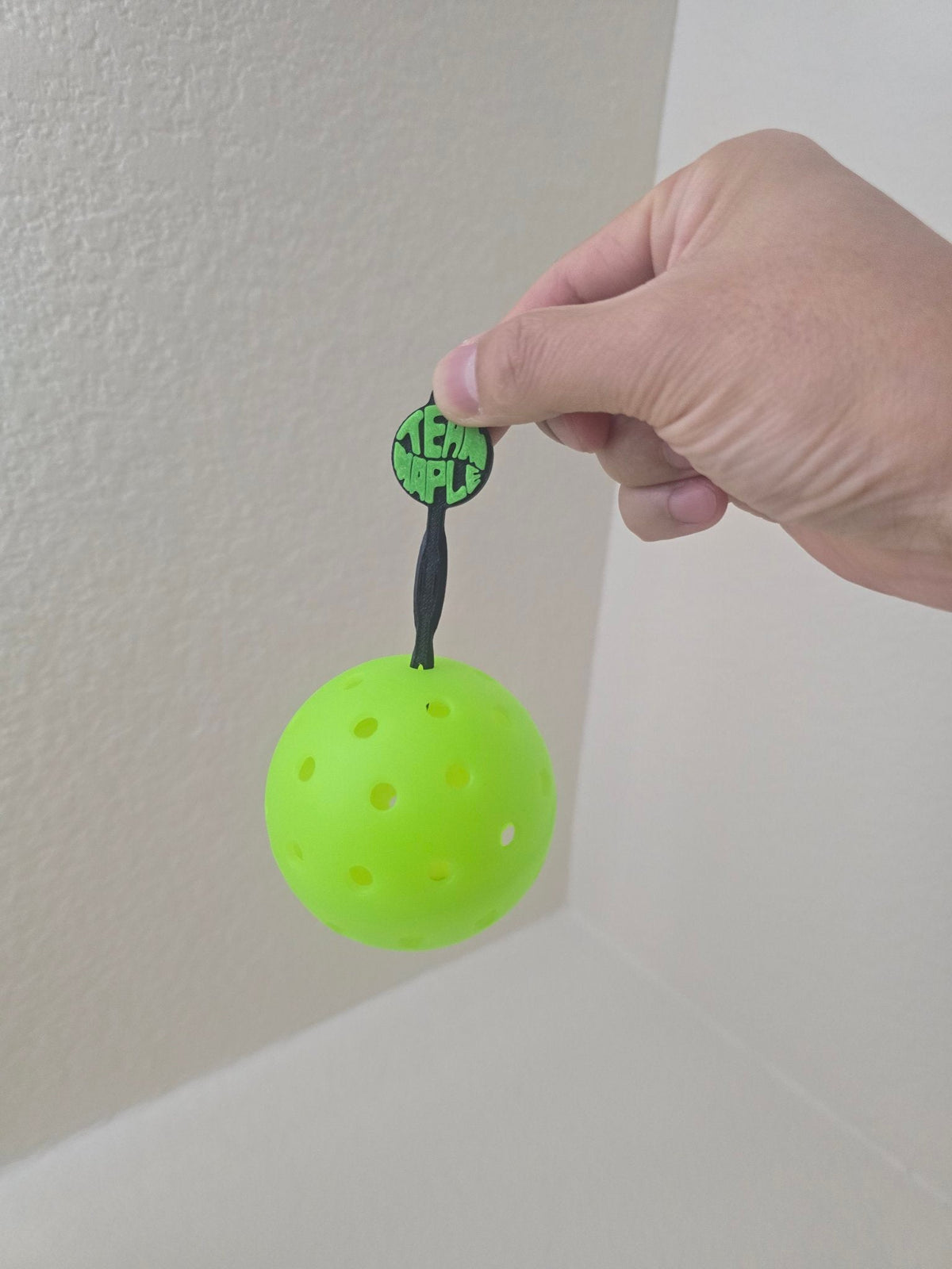 Custom TEAM MAPLE ball picker picking up a pickleball